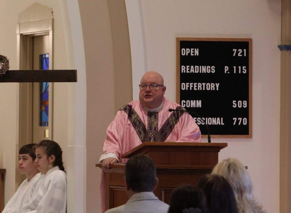 Father David Misbrener, wearing Rose vestments, thanks bishop and parishioners at the end of Mass