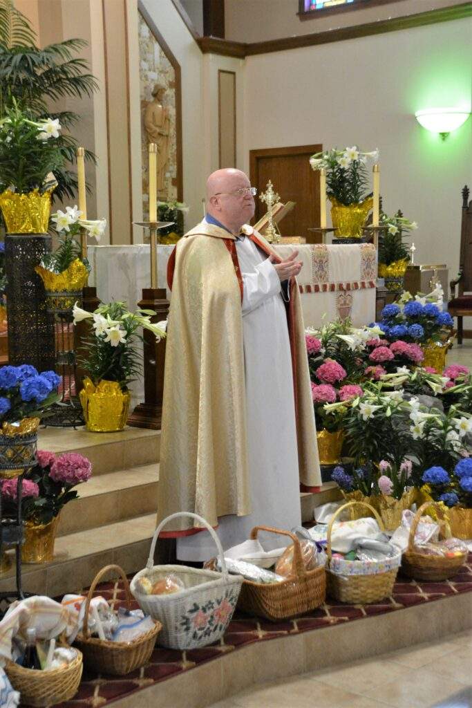 Fr. Kelly blesses more than 20 Easter Baskets around the altar at St. Rose.