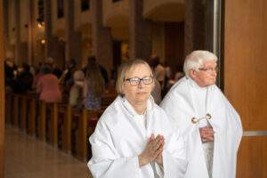 servers praying as they exit the cathedral