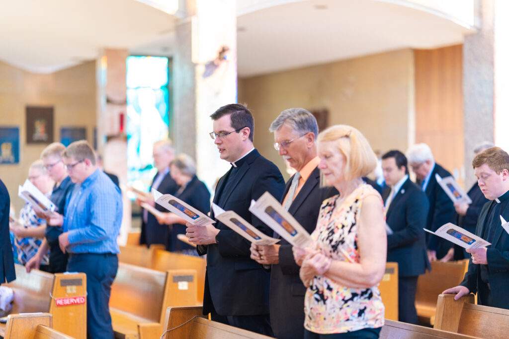 Father Rovnak sings a hymn with his family