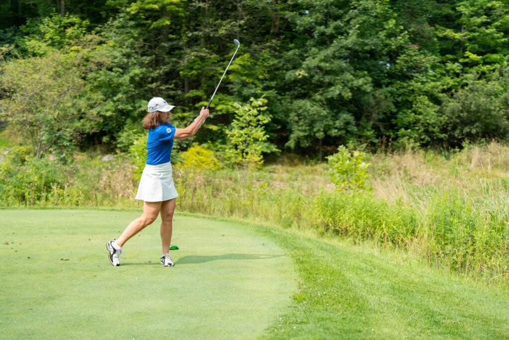 woman swings her club