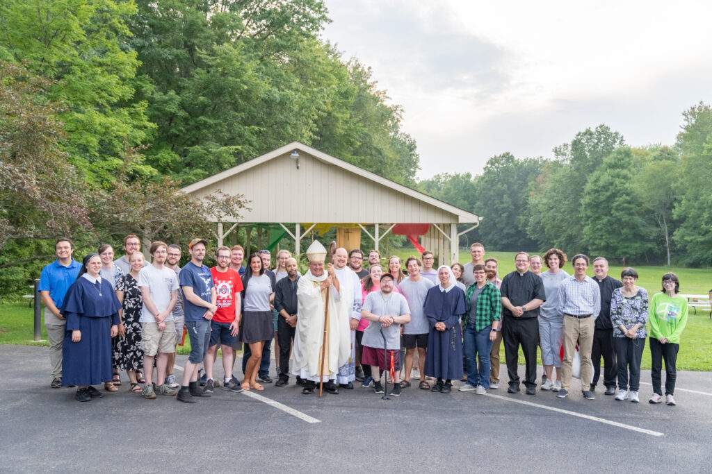 Bishop poses with the attendees of World Youth Day