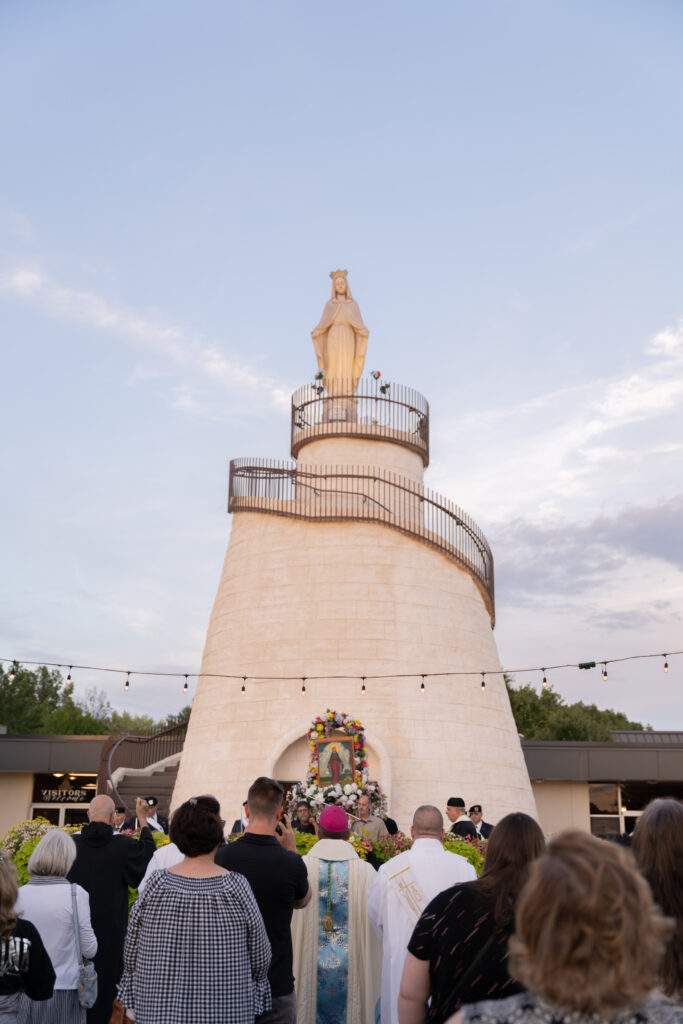 Crowd gathers outside the shrine as the sun sets