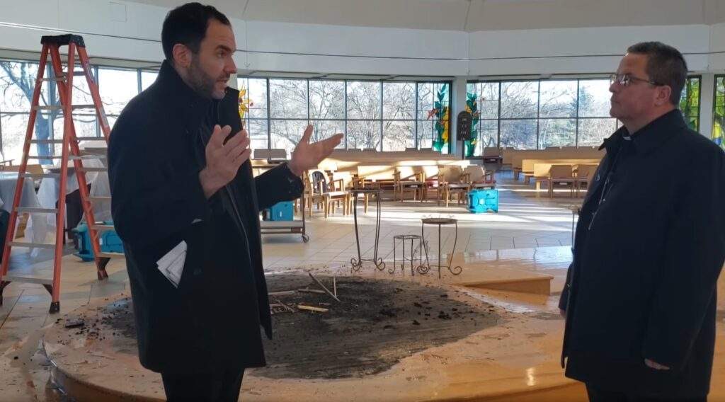 Bishop Bonnar and Father Cicero stand around the burnt altar at Blessed Sacrament.