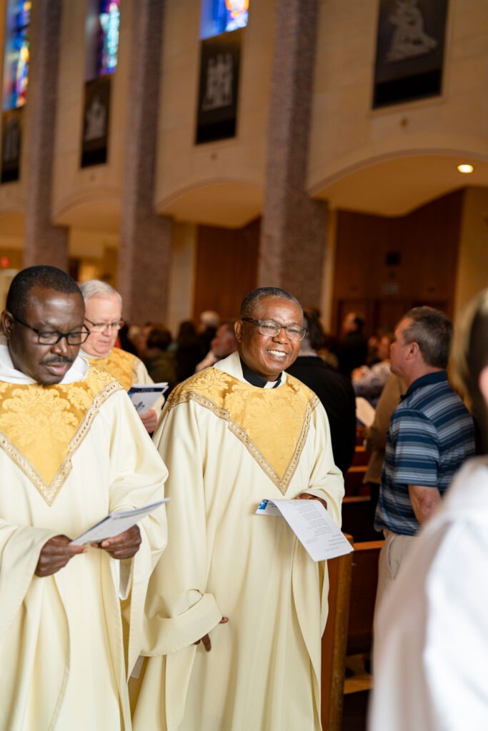 Priests smile as they process out of the church at the end of the White Mass. Photo by Brian Keith.