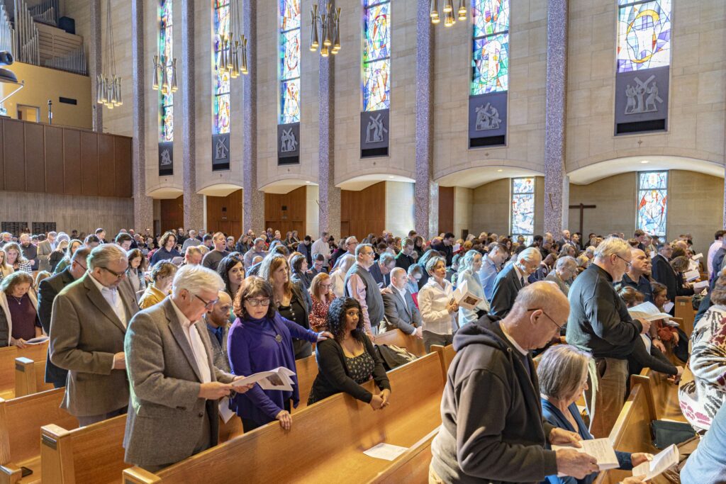Godparents stand with future confirmands during the Rite of Election. Photo by Brian Keith.