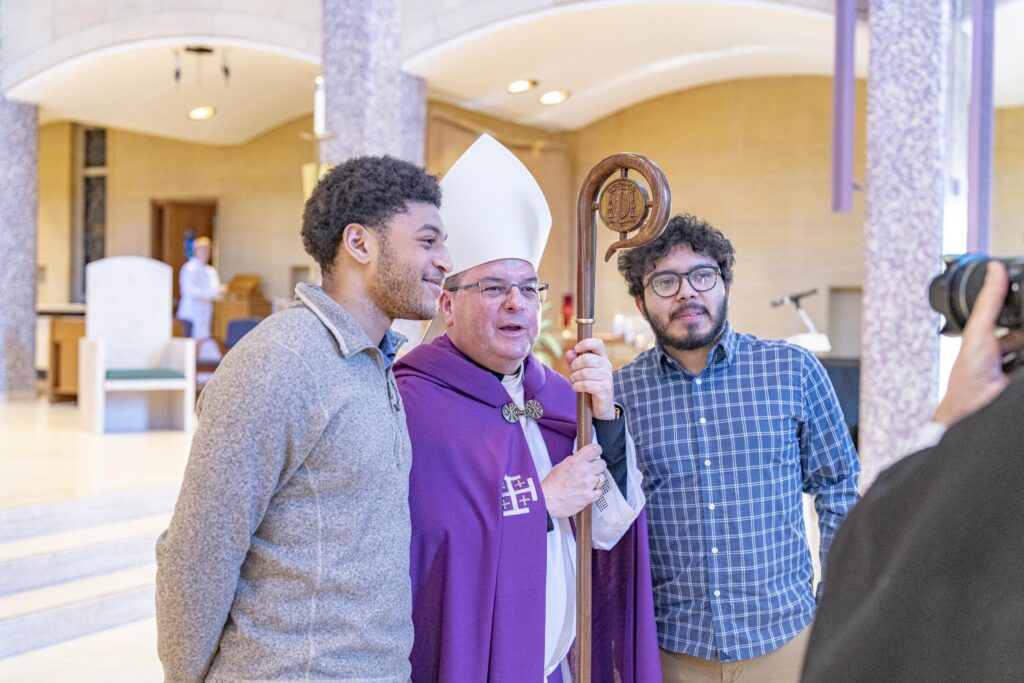 Two men pose for a photo with Bishop Bonnar after the Rite of Election. Photo by Brian Keith.