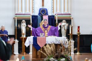 Father Leo Wehrlin says the Eucharistic Prayers on Ash Wednesday at Holy Trinity Parish in East Liverpool