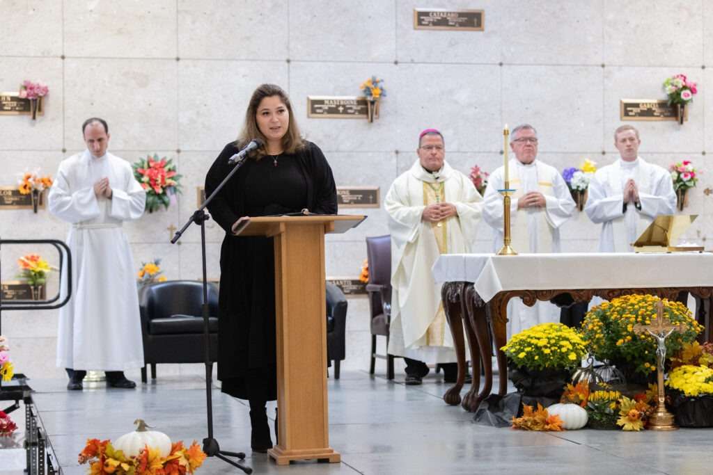 Lector reads Scripture at St. Callistus Feast Day on October 14, 2024, at Calvary Cemetery in Massillon.