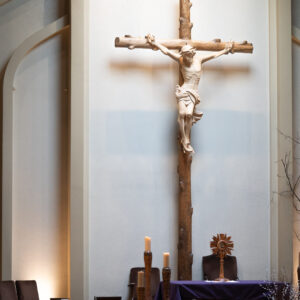 All kneel before the monstrance at St. Joan of Arch Parish.