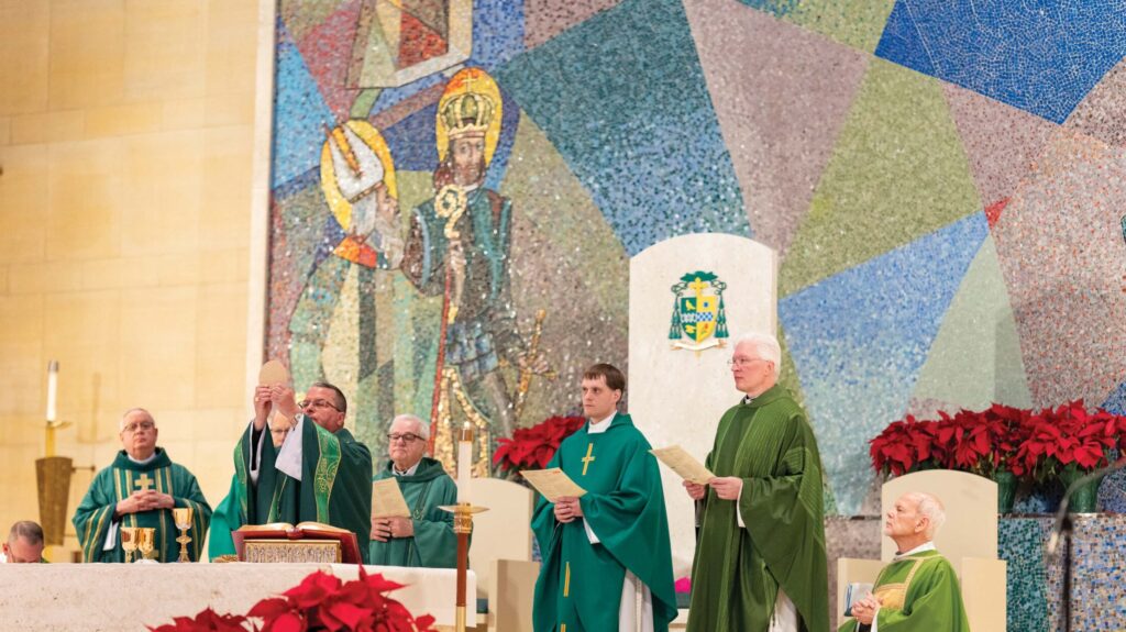 Bishop Bonnar raises the host during the Eucharistic Prayers. Photo by Brian Keith