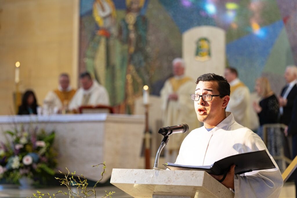 Cantor sings at the cantor stand during Holy Thursday 2024. Photo by Brian Keith.
