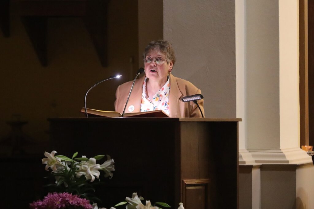 Older woman stands at the ambo at St. Joseph Parish in Mogadore during the Easter Vigil 2024. Photo by Ed Hall, Jr.