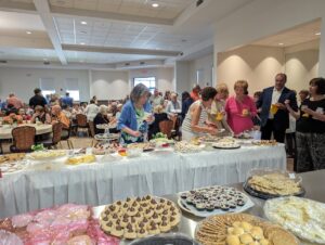 Guests visit a massive cookie table in the new parish center at Mt. Carmel in Niles. Photo by Karen S. Kastner.