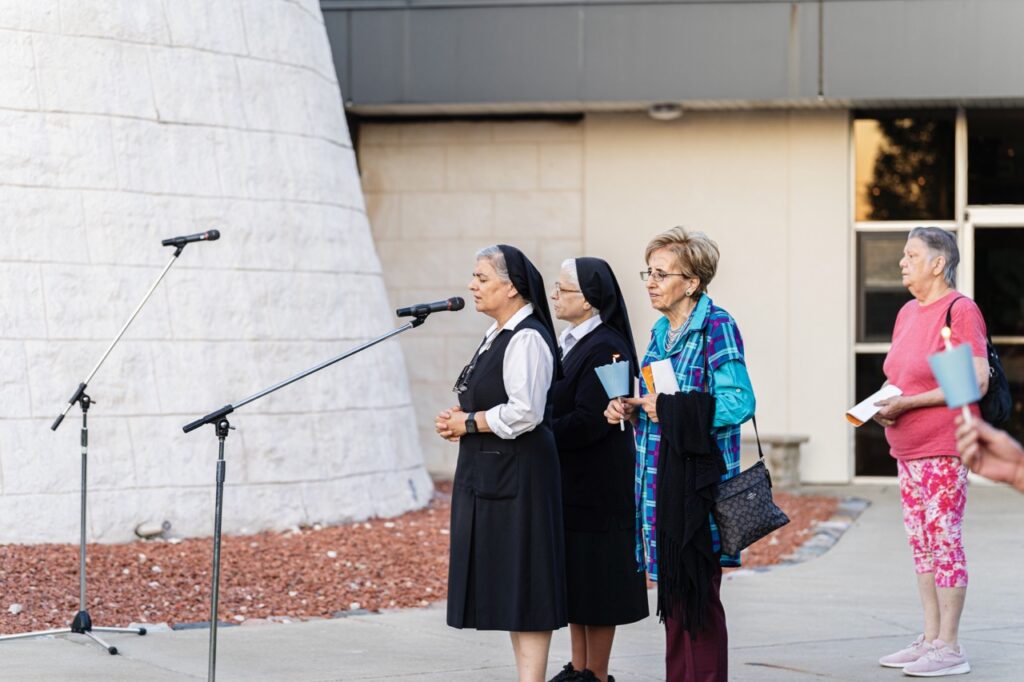 Religious sisters sing outside the shrine at for the Assumption Pilgrimage in North Jackson. Photo by Brian Keith.