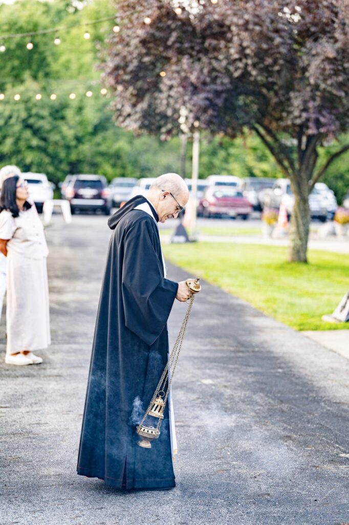Priest swings incense at for the Assumption Pilgrimage in North Jackson. Photo by Brian Keith.