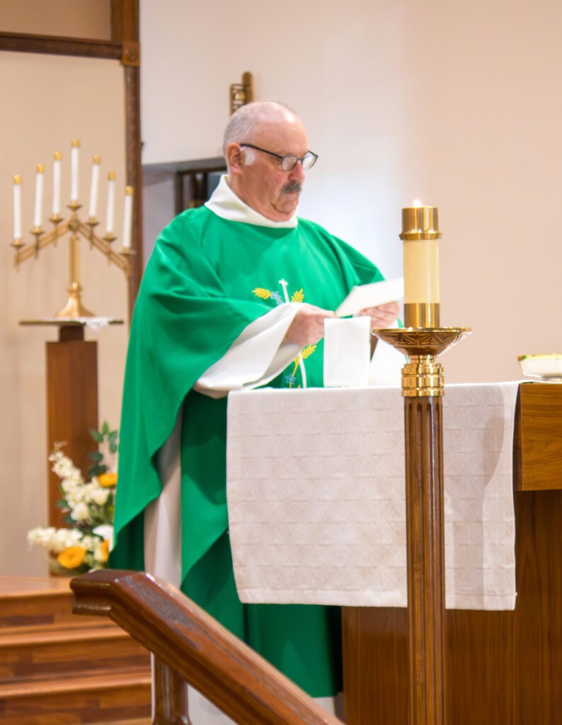 Father rogers delivers the homily at his retirement Mass