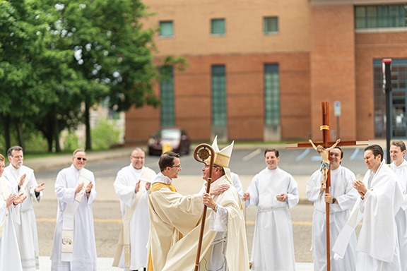 Deacon Travis Seagraves greets bishop bonnar after his ordination to the diaconate