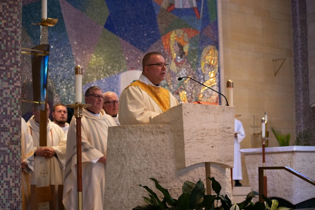 Deacon Bill Bancroft does the readings during Mass. Photo by Courtney Poullas.