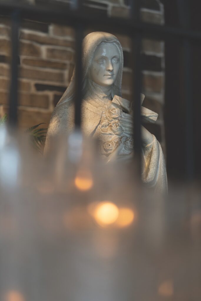 statue of St. Therese of Liseux, with hands folded in prayer.