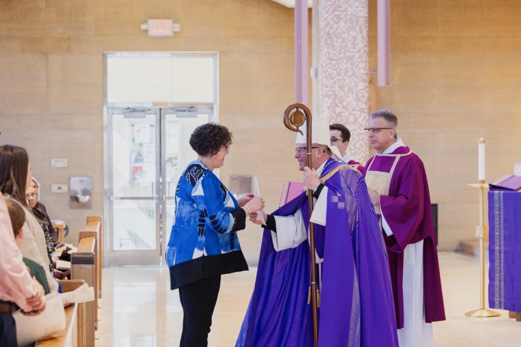 Bishop Bonnar receives the gifts Rite of Election. Photo by Brian Keith.