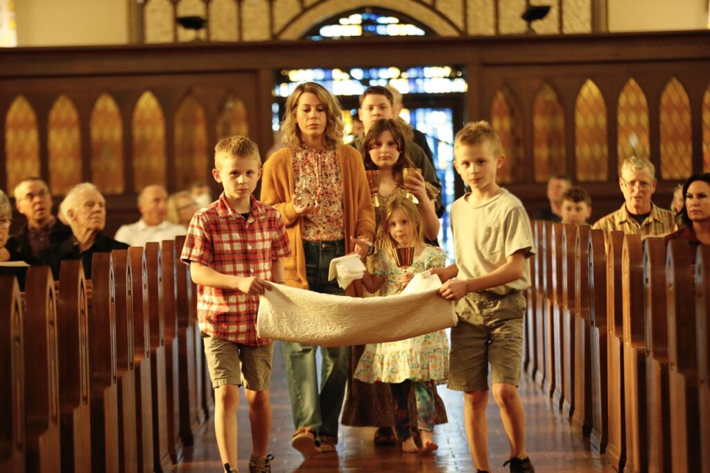 Children bring up gifts at St. Paul Parish in Salem