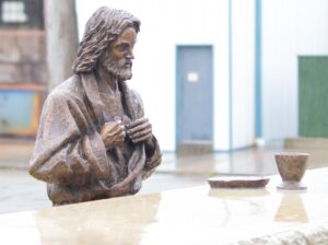 Image of statue depicting jesus, alone, at the Last Supper. Photo by Courtney Poullas