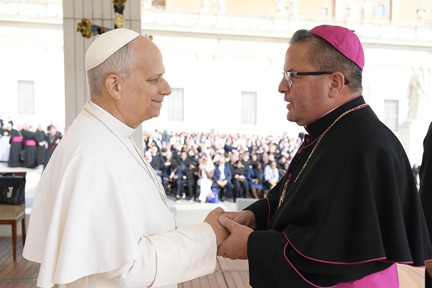Bishop being greeted by Pope XIV on his pilgrimage in Rome.