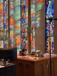a man plays the organ in the choir loft at the cathedral