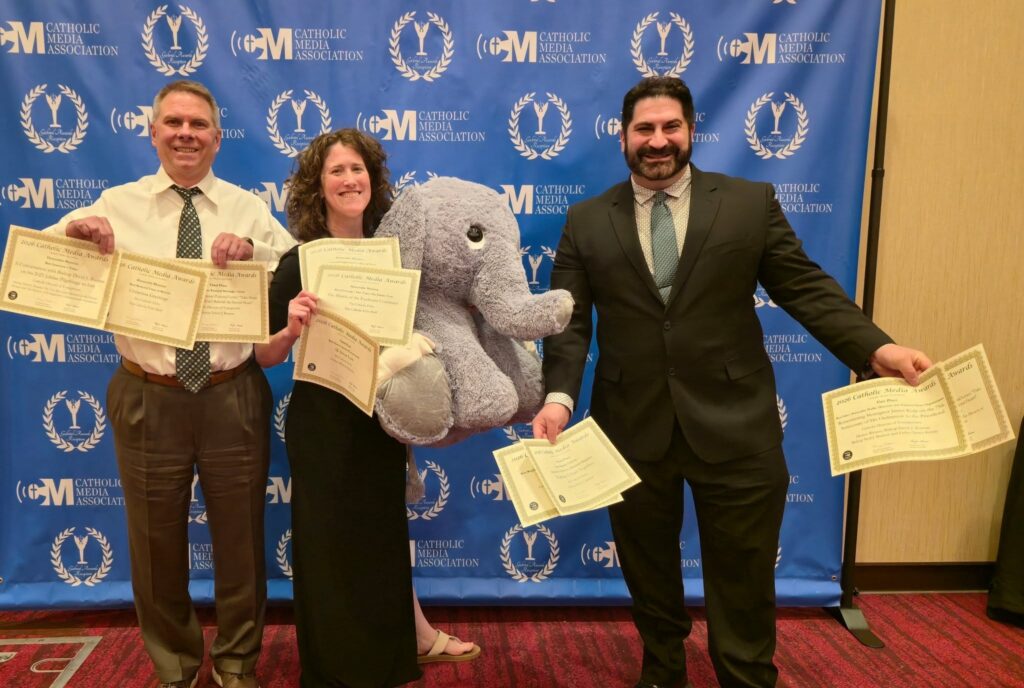 Communication department members hold their awards.