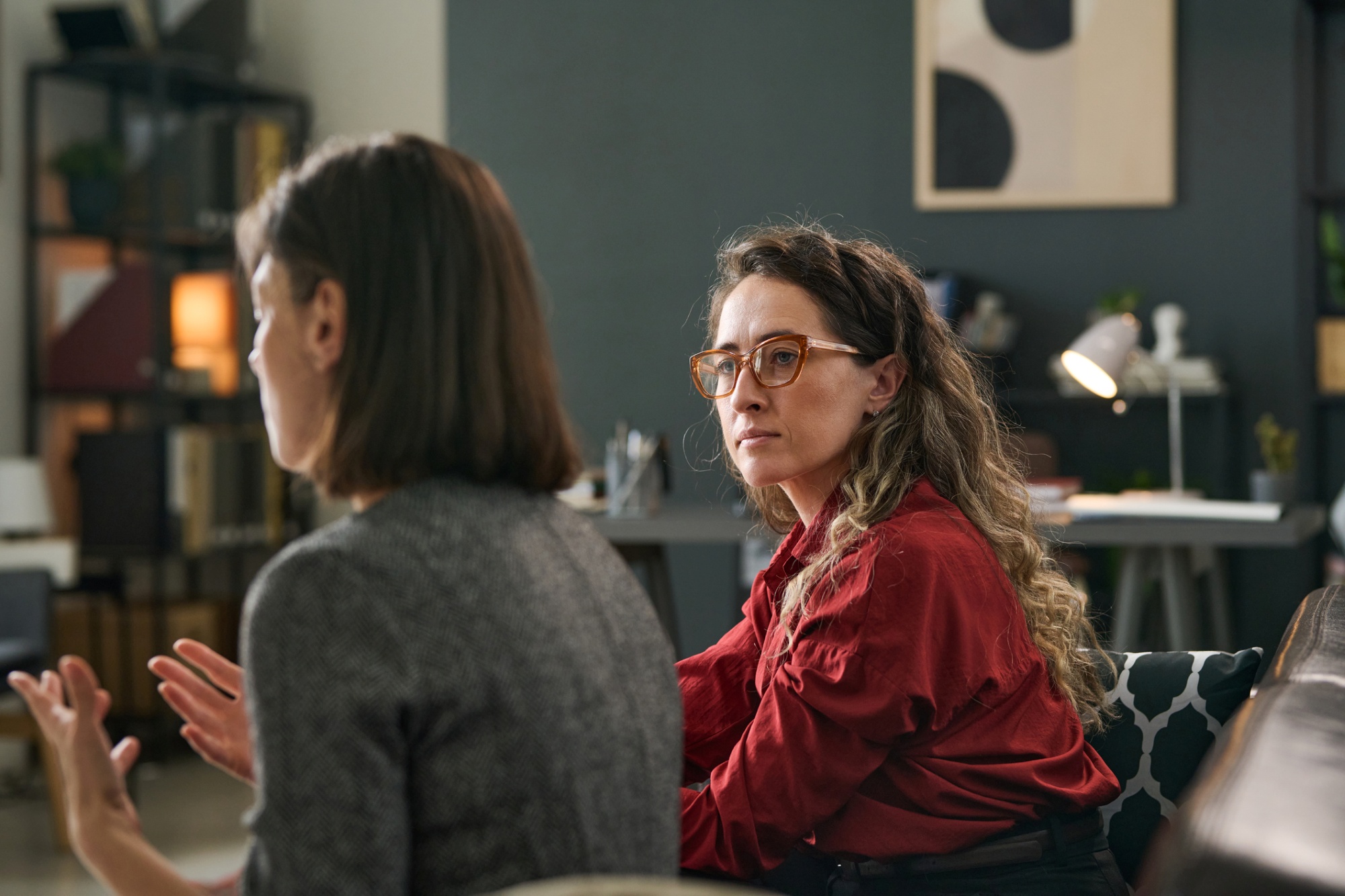 Two women sit down and discuss their faith.