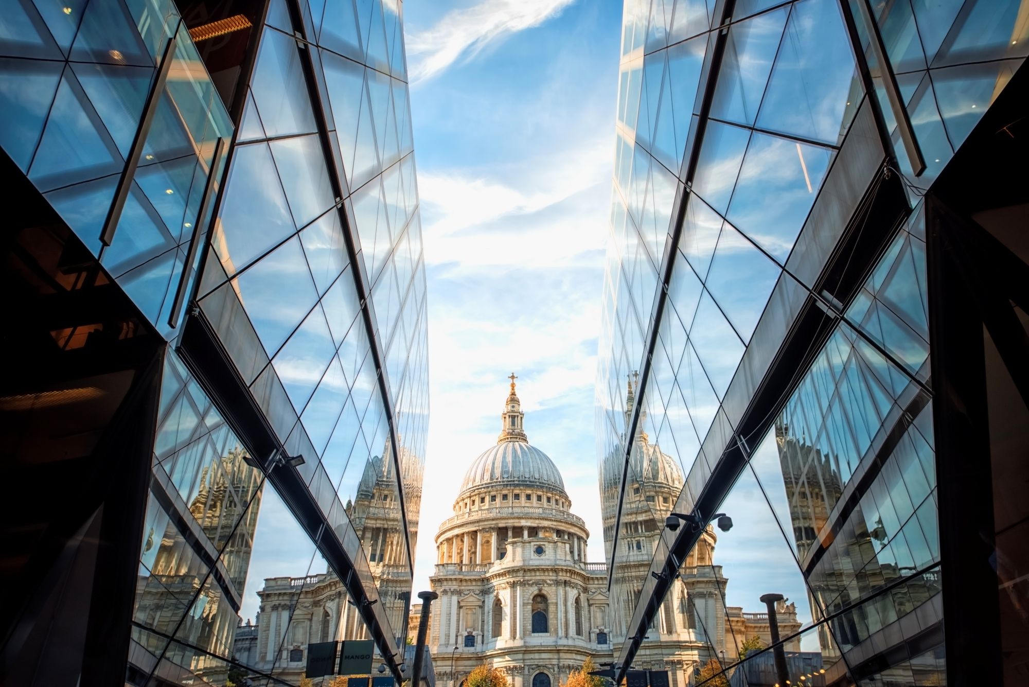 The Catholic Surge: The faith remains constant while secularism dies. A church rises between two modern buildings.