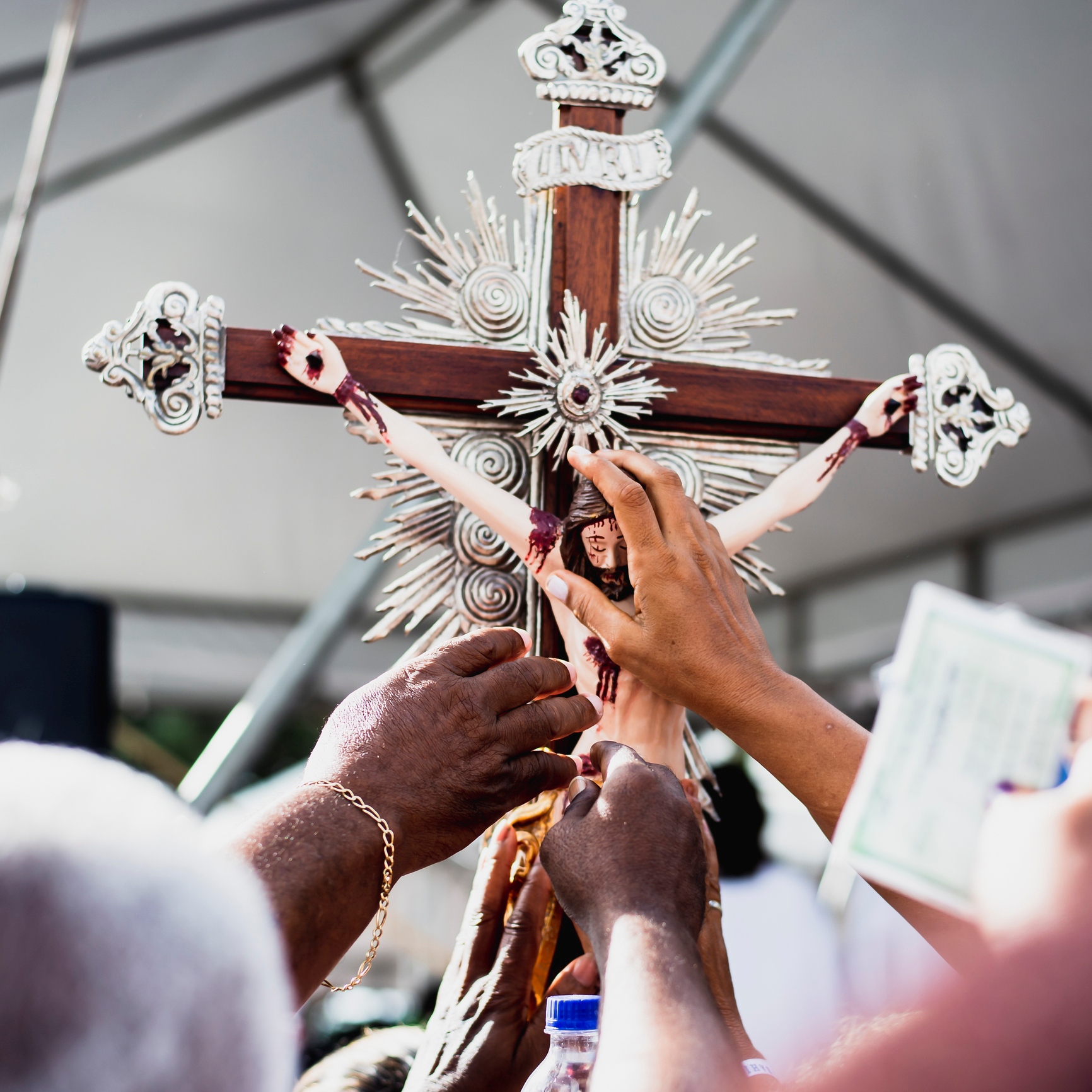 Catholics celebrating the Feast of the Exaltation of the Cross in a Church.