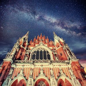 The facade of St. Joseph's Church in Krakow Poland with a view of the Milky Way Galaxy in the night sky behind, symbolizing the surprising connection between Star Trek and the legacy of the Church.