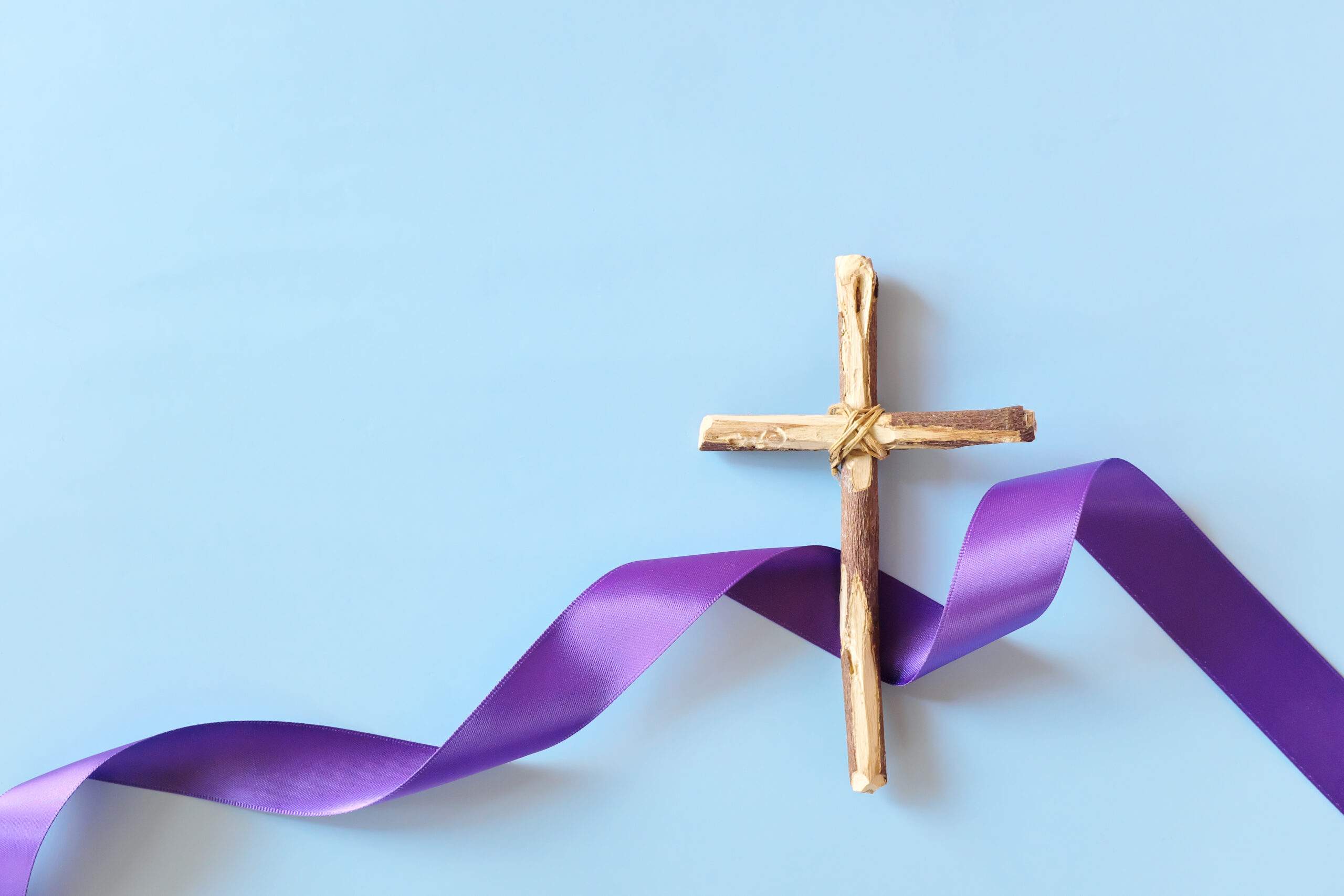 purple ribbon and cross denoting Lent.