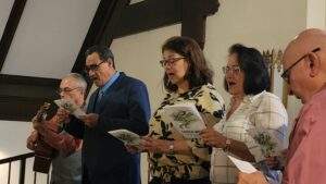 Five singers read from music in the choir loft at Immaculate Conception Ravenna.