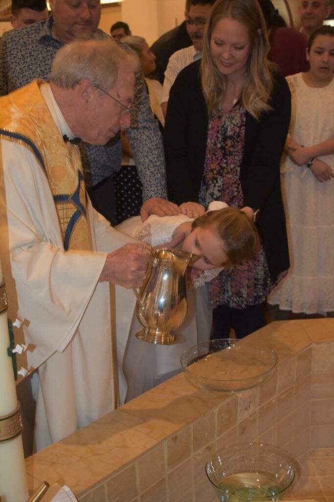 Fr. Thomas baptizes a young girl