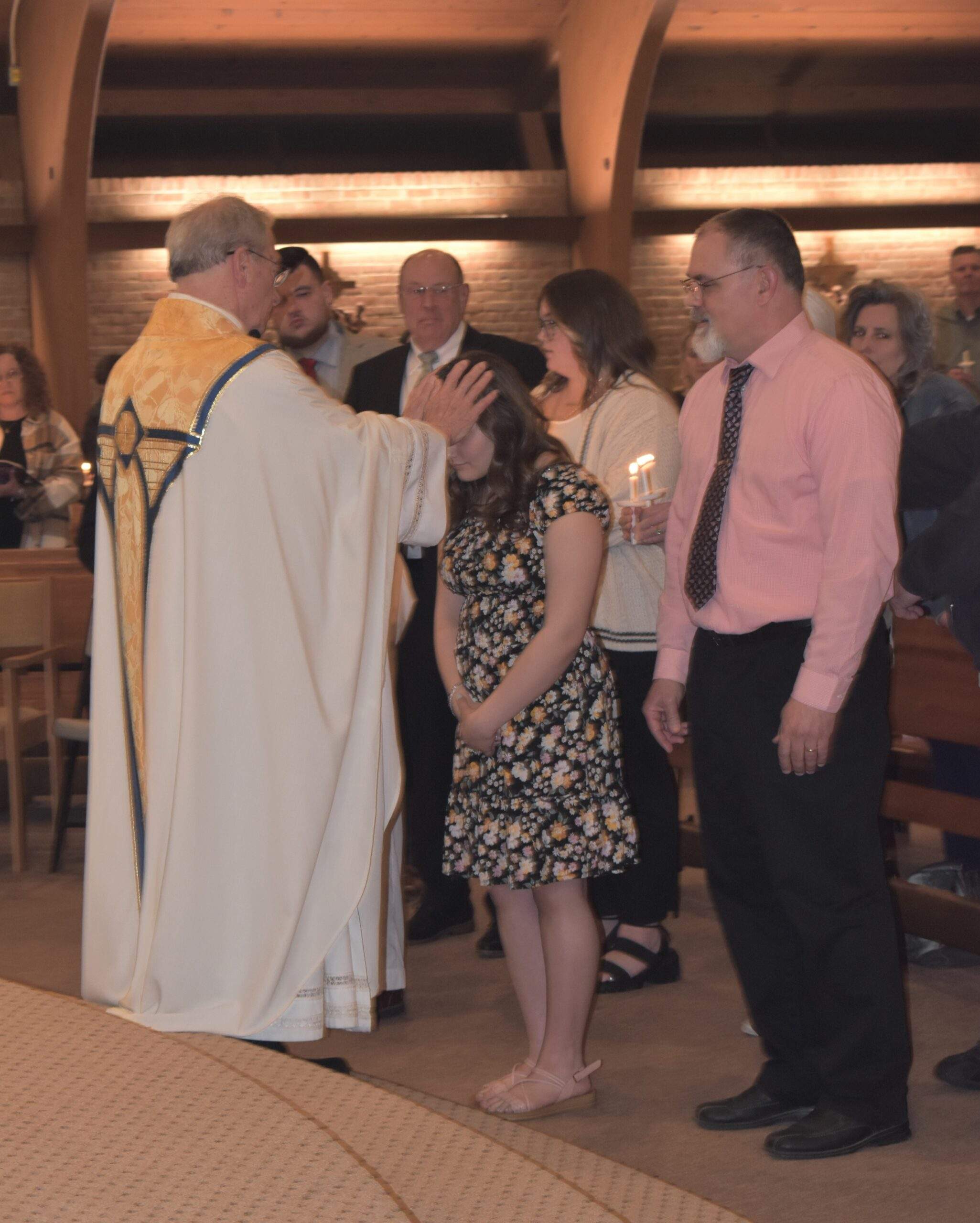 Fr. Thomas welcomes 4 confirmands into the Church