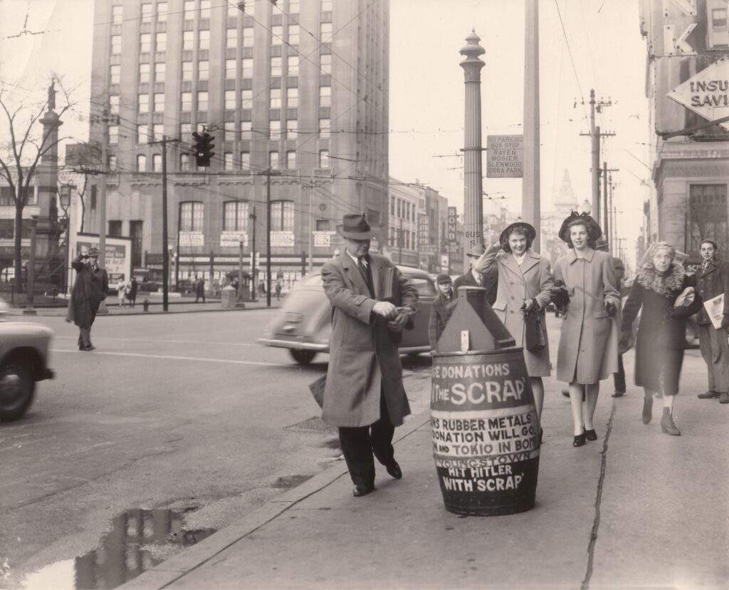 1940s photo of people donating scrap on a sidewalk in Youngstown.