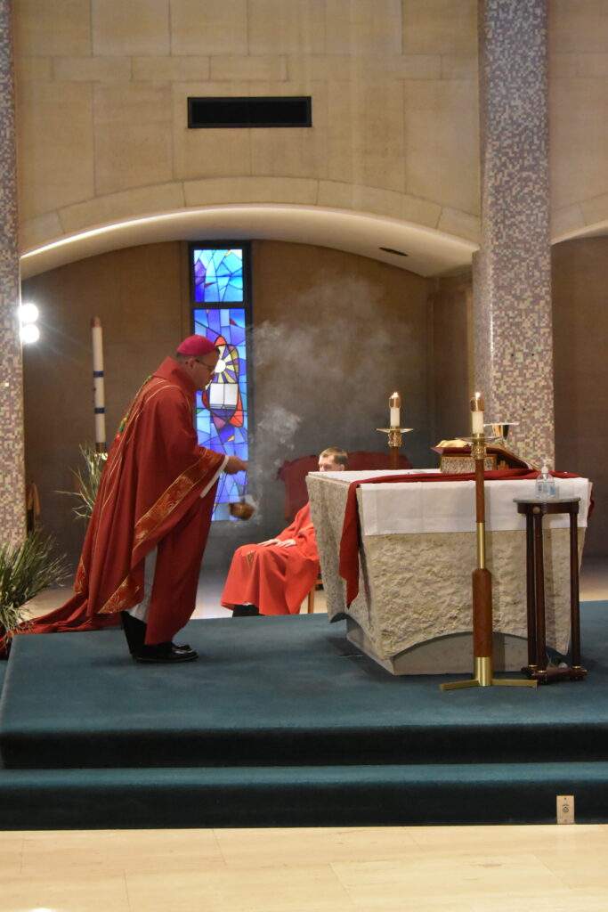 Bishop Bonnar incenses the altar during Palm Sunday Mass