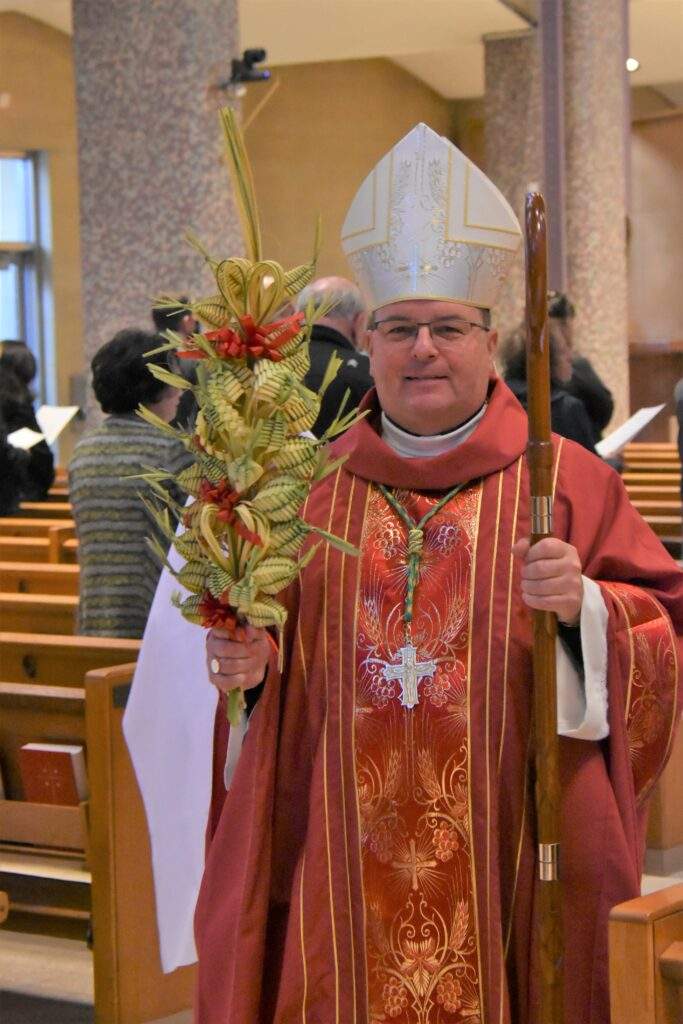 Bishop Bonnar holds palms during Palm Sunday Mass