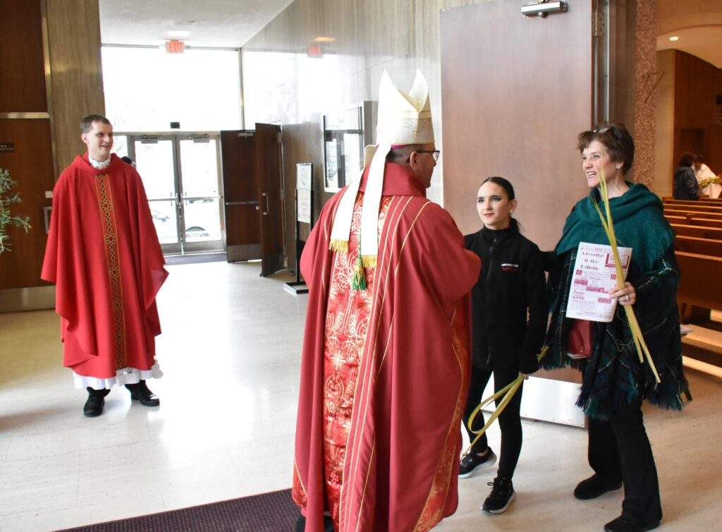 Bishop Bonnar greets parishioners during Palm Sunday Mass