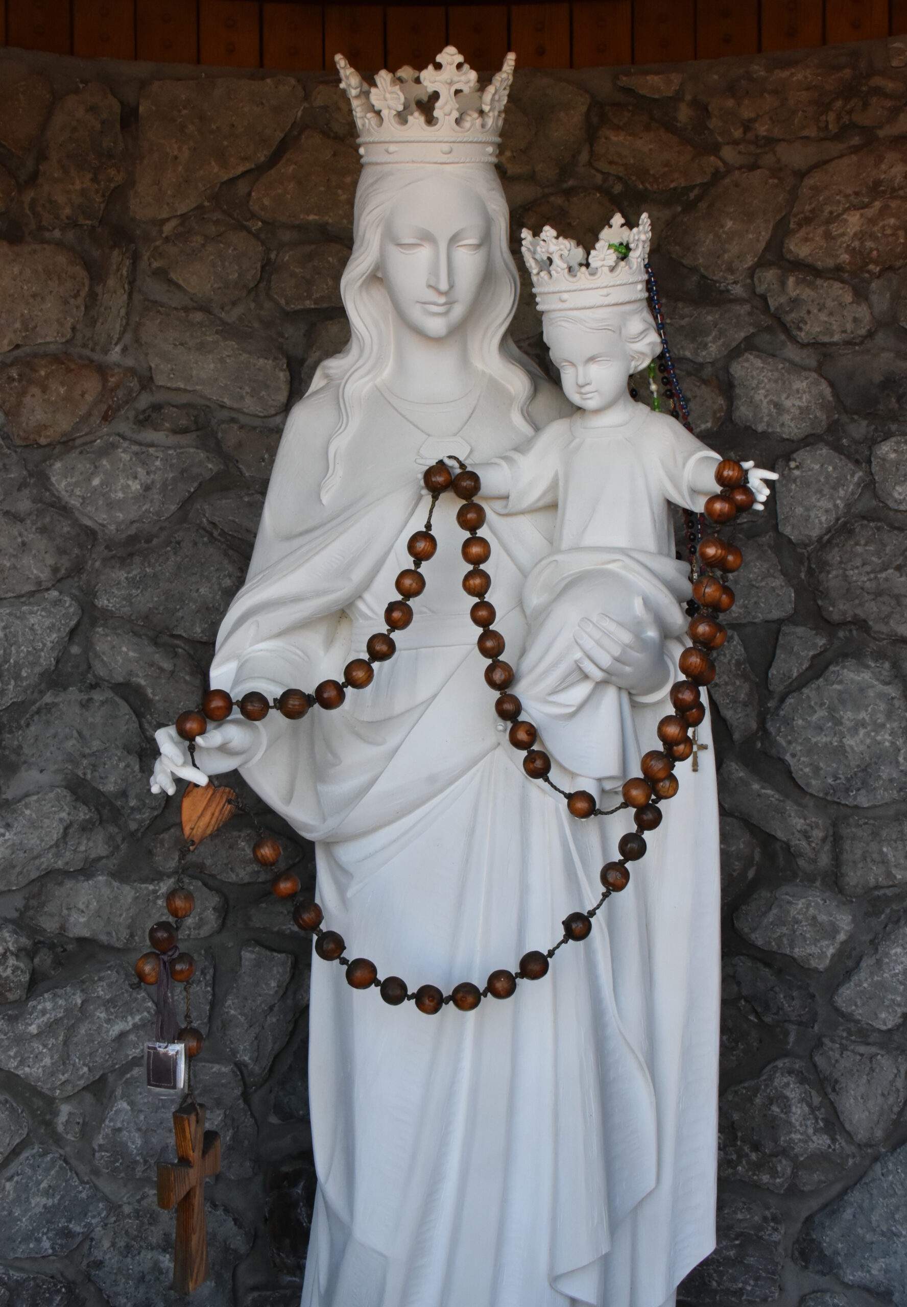 Statue of the Blessed Mother, holding baby Jesus and rosary beads at Holy Rosary Parish in Lowellville