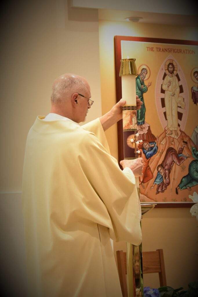 The deacon places the Easter candle during the Easter Vigil Mass in Columbiana