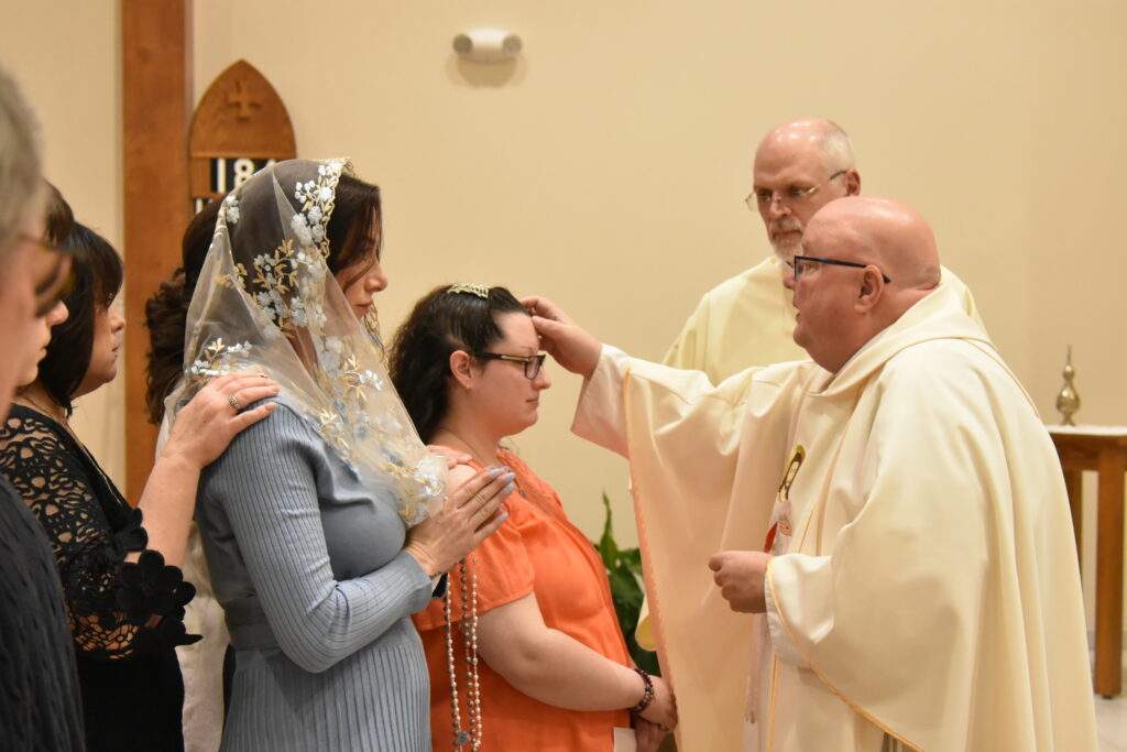 Fr. Misbrener blesses a confirmation candidate