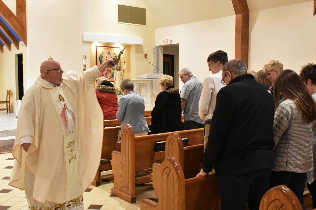 Fr. David Misbrener performs the sprinkling rite during the Easter Vigil in Columbiana
