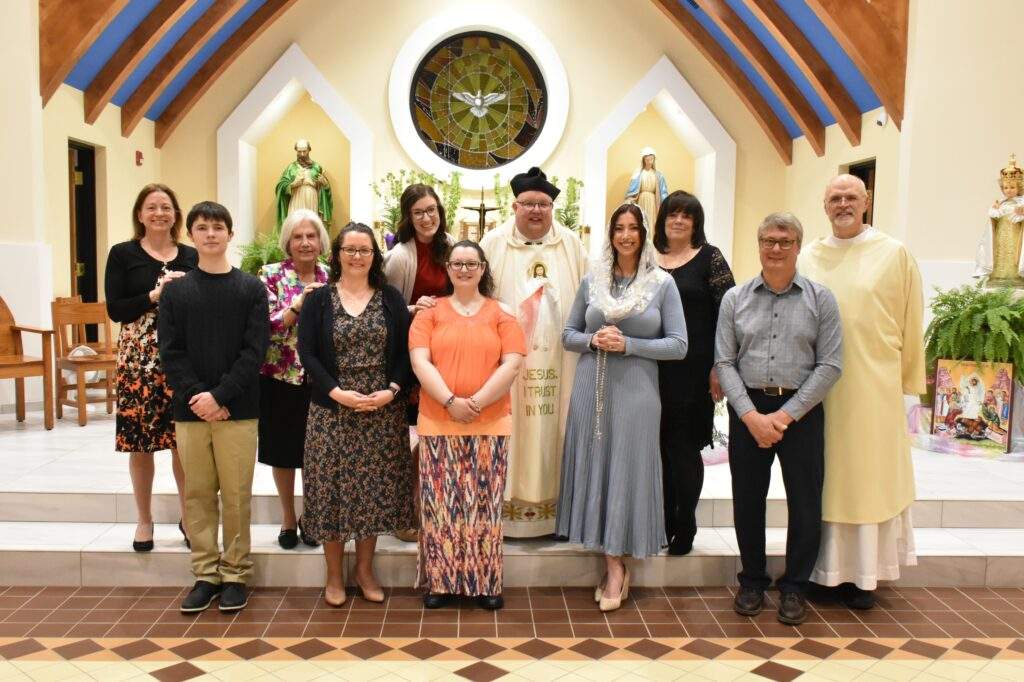 Candidates pose in front of the altar in columbiana after the Easter Vigil