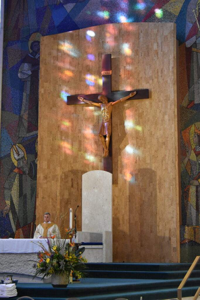 Colored lights from the Stained Glass Windows illuminate the crucifix at St. Columba Cathedral