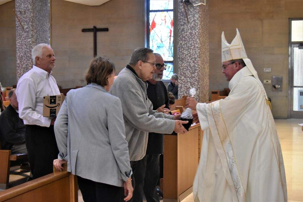 Parishioners bring the gifts forward during Holy Thursday mass.