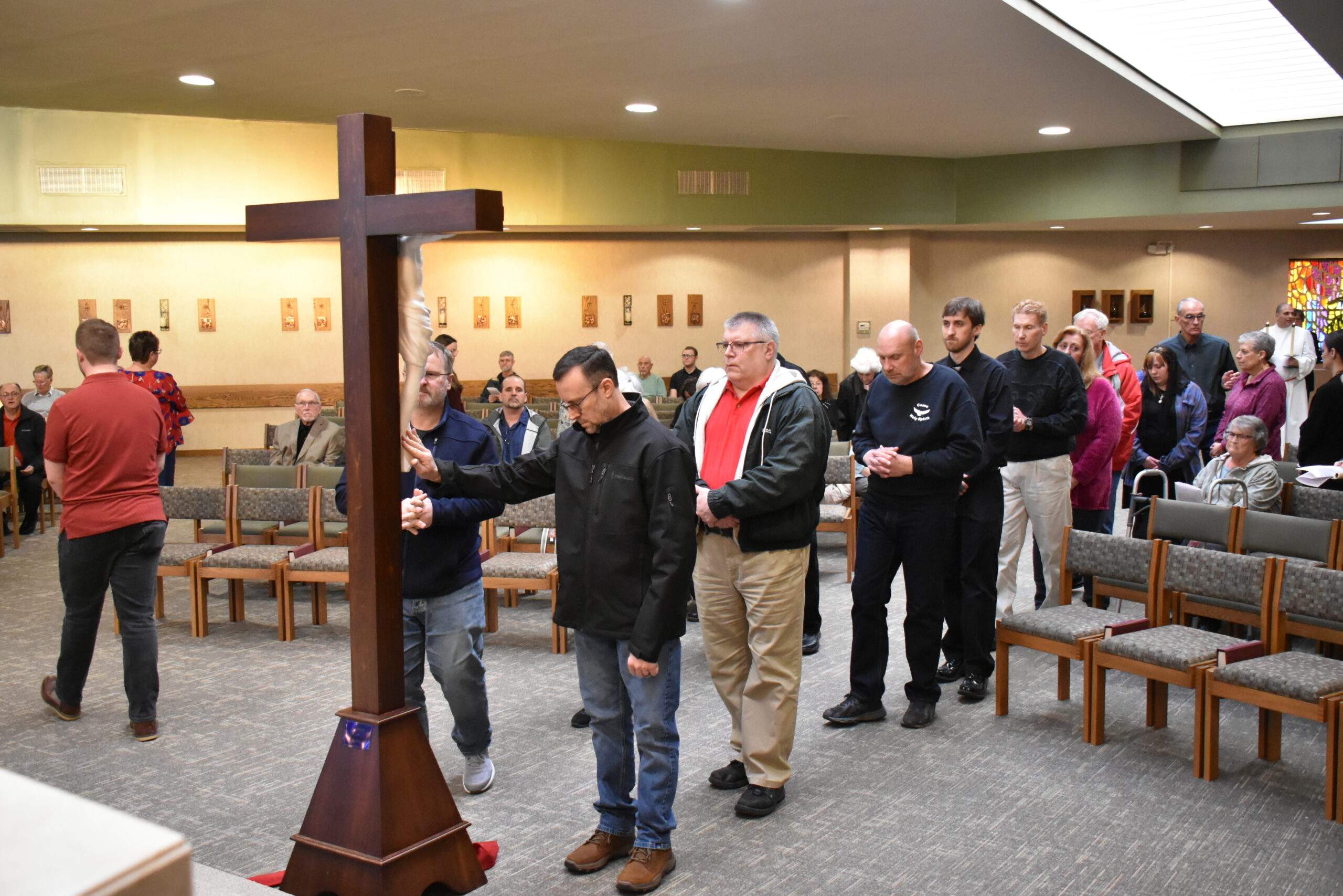 Parishioners venerate the cross at St. William Parish on Good Friday